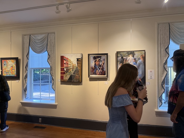 Visitors viewing artwork at Cary juried art exhibition 2025