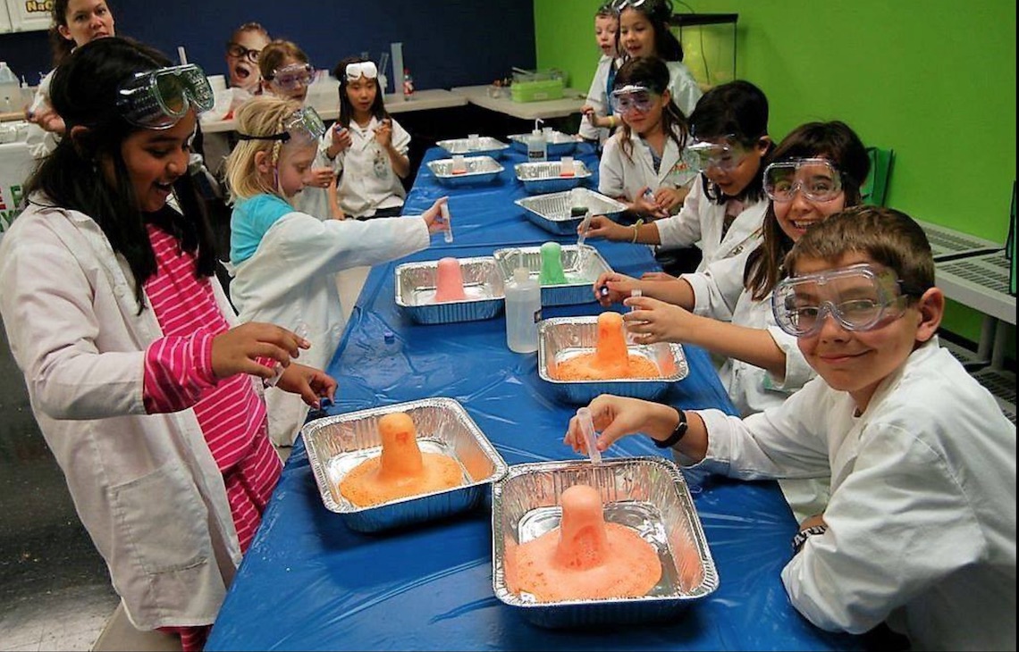 Group of children conducting science experiments at Science Fun For Everyone! Summer Camp