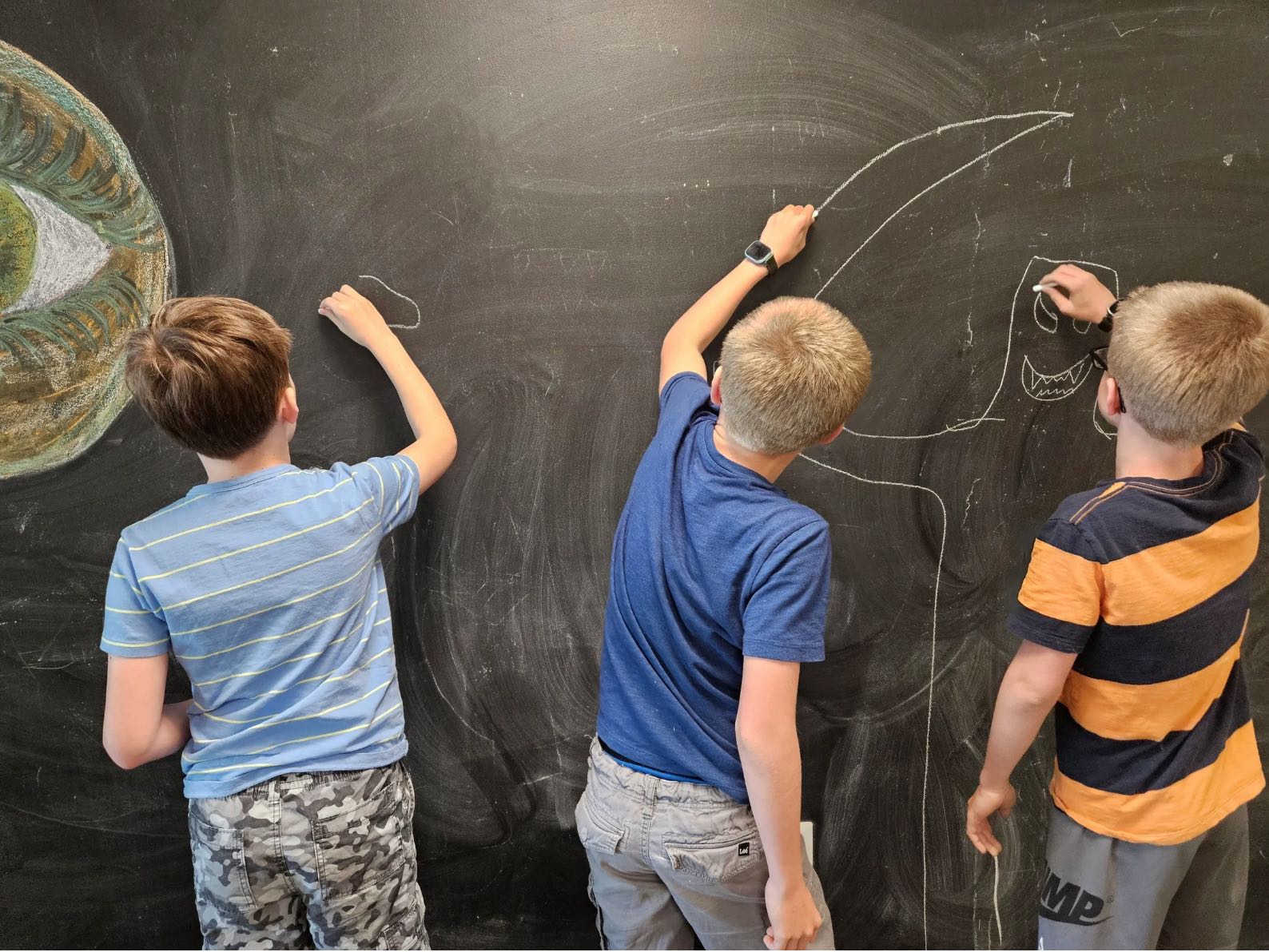 Kids crafting stories at Young Writers' Institute Summer Camp